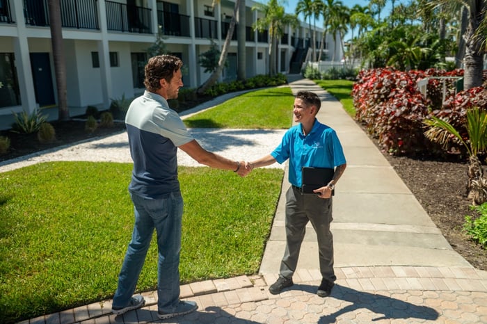 Account manager and property manager commercial shaking hands 1