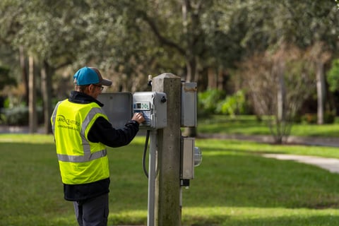 crew member inspecting irrigation controls