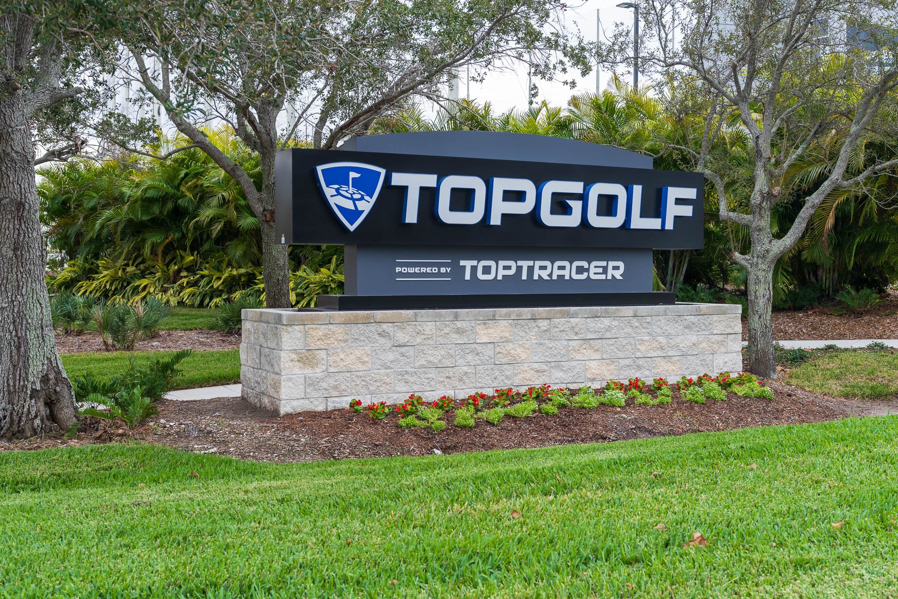 landscaping flower beds around Top Golf entrance sign 