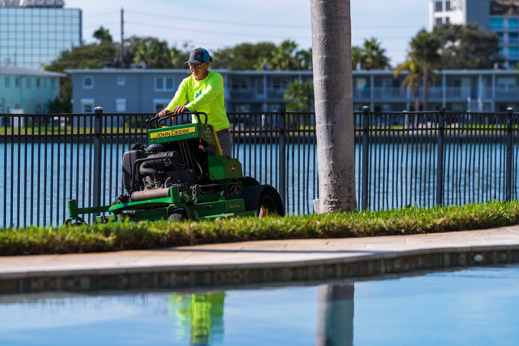 residential landscape maintenance crew mowing lawn 