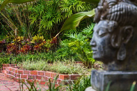 statue in landscape garden beds