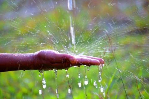 hand catching dripping water